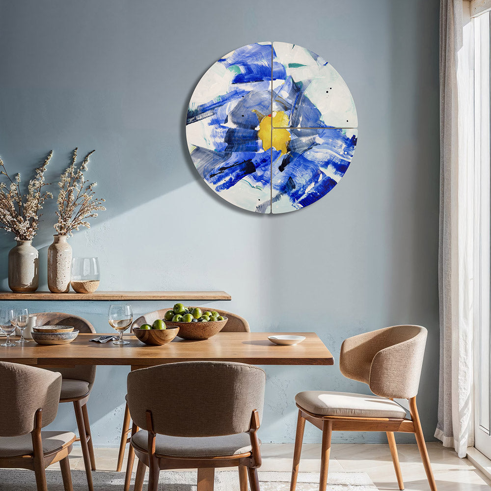 Anemone Guise circular wall sculpture by Kirsty Black mounted on blue-grey wall above timber dining table with linen upholstered chairs, wooden bowls, wine glasses and dried flower stems in ceramic vases