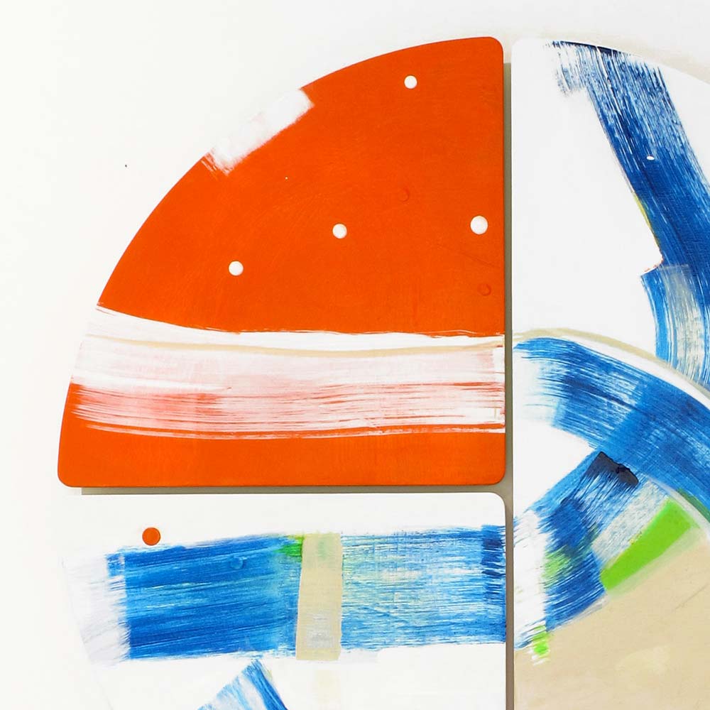 Detail of Swashbuckle Peg wall sculpture by Kirsty Black showing a solid orange quarter-circle tile with white dot accents meeting sweeping cobalt blue brushwork across the panel join.