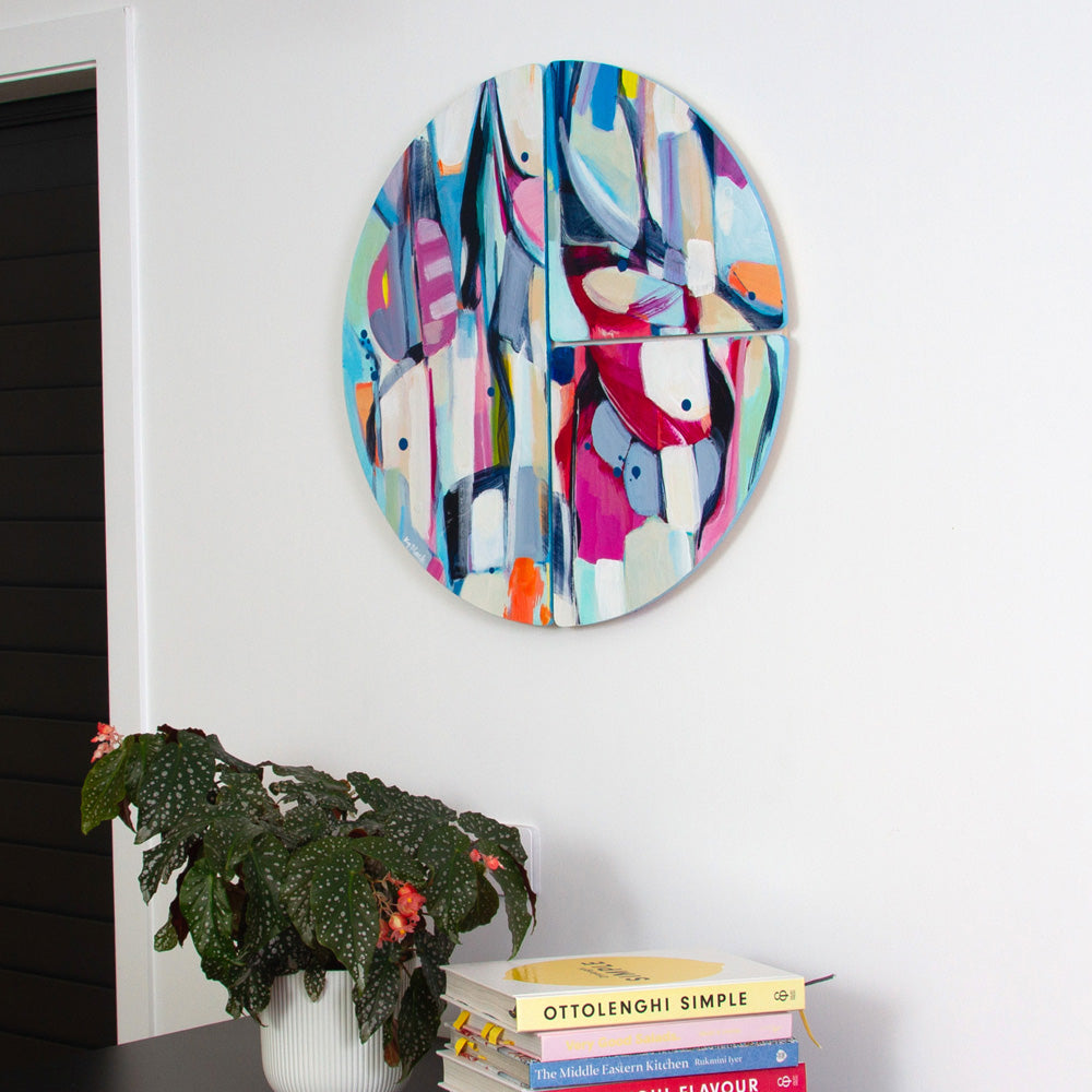 Damselfly Shimmy, colourful circular abstract artwork hanging on white wall