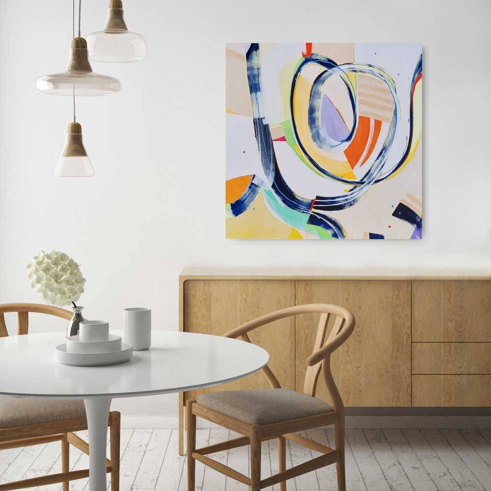 Nattering Gnat abstract painting by Kirsty Black hung on white wall above timber sideboard beside round white dining table with wishbone chairs and pendant lights, showing scale of 1010x1010mm square canvas in Scandinavian-style dining space