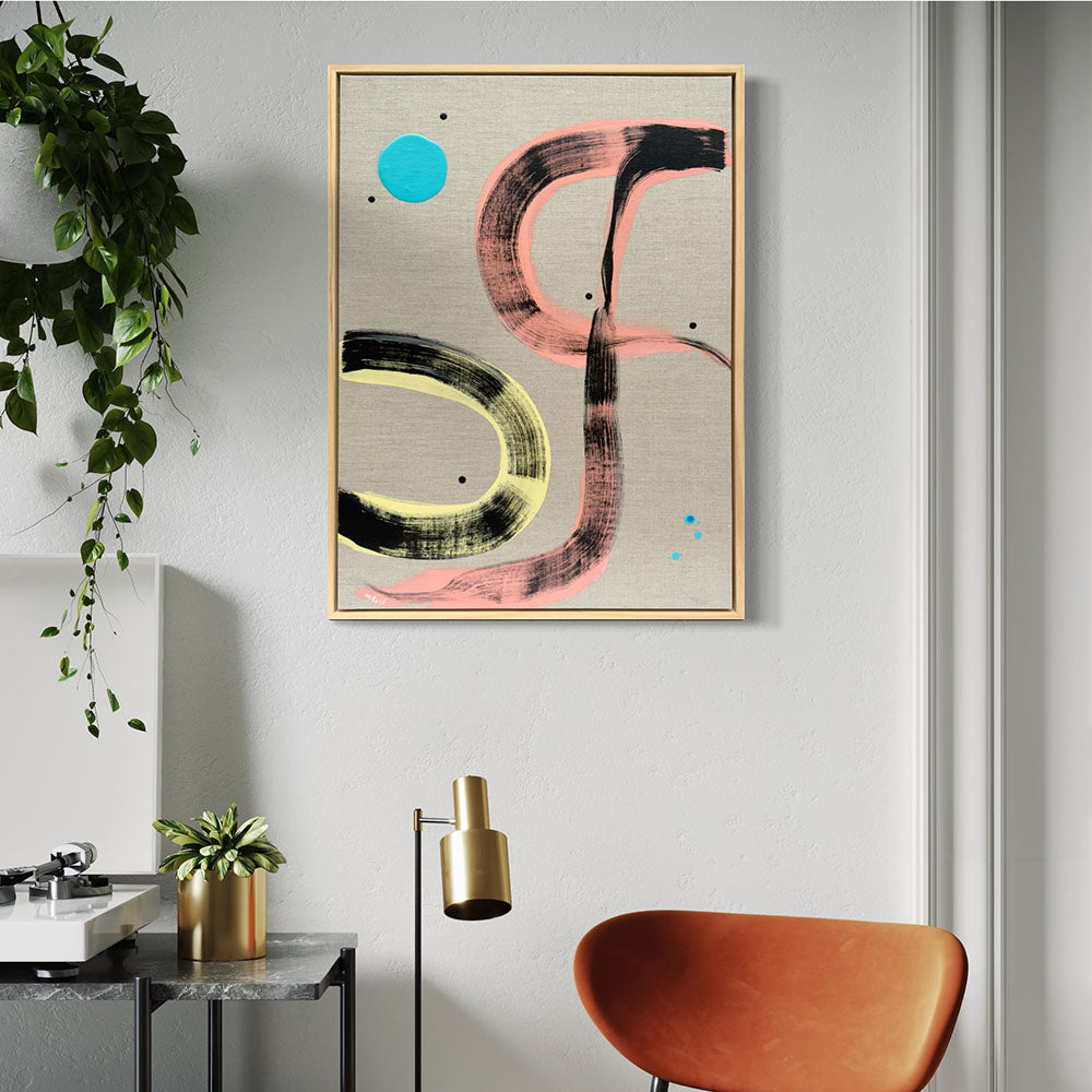 Pussy Cat Prowl framed abstract painting by Kirsty Black on grey wall in contemporary living space with trailing ivy plant, gold floor lamp, tan leather chair and marble side table