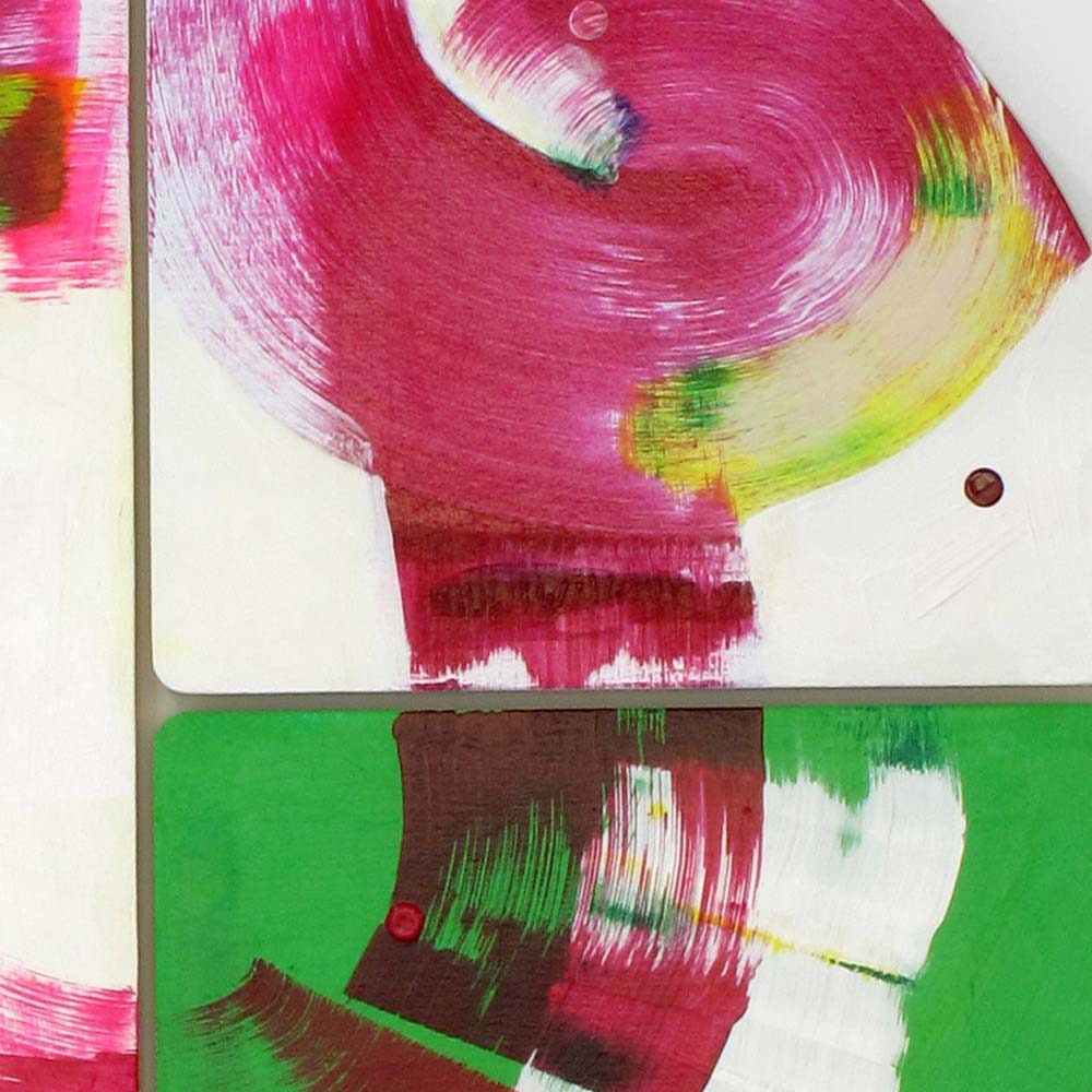 Detail of Roller Disco Dames wall sculpture by Kirsty Black showing a spiralling magenta vortex on white meeting a vivid green tile below, with small magenta dot accent at the panel join.