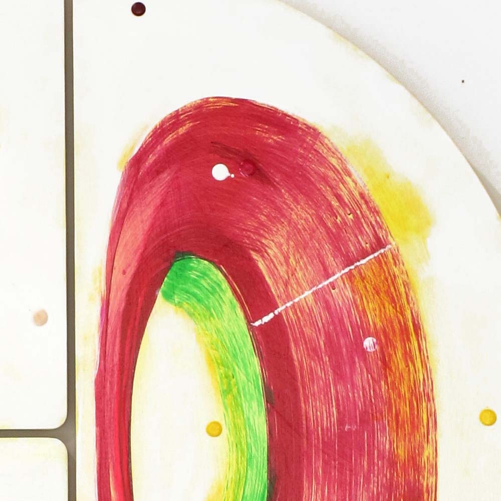 Detail of Sausage Dog Wheelie wall sculpture by Kirsty Black showing a sweeping crimson arc encircling a vivid green form with warm golden yellow blending at the edges and white and yellow dots.
