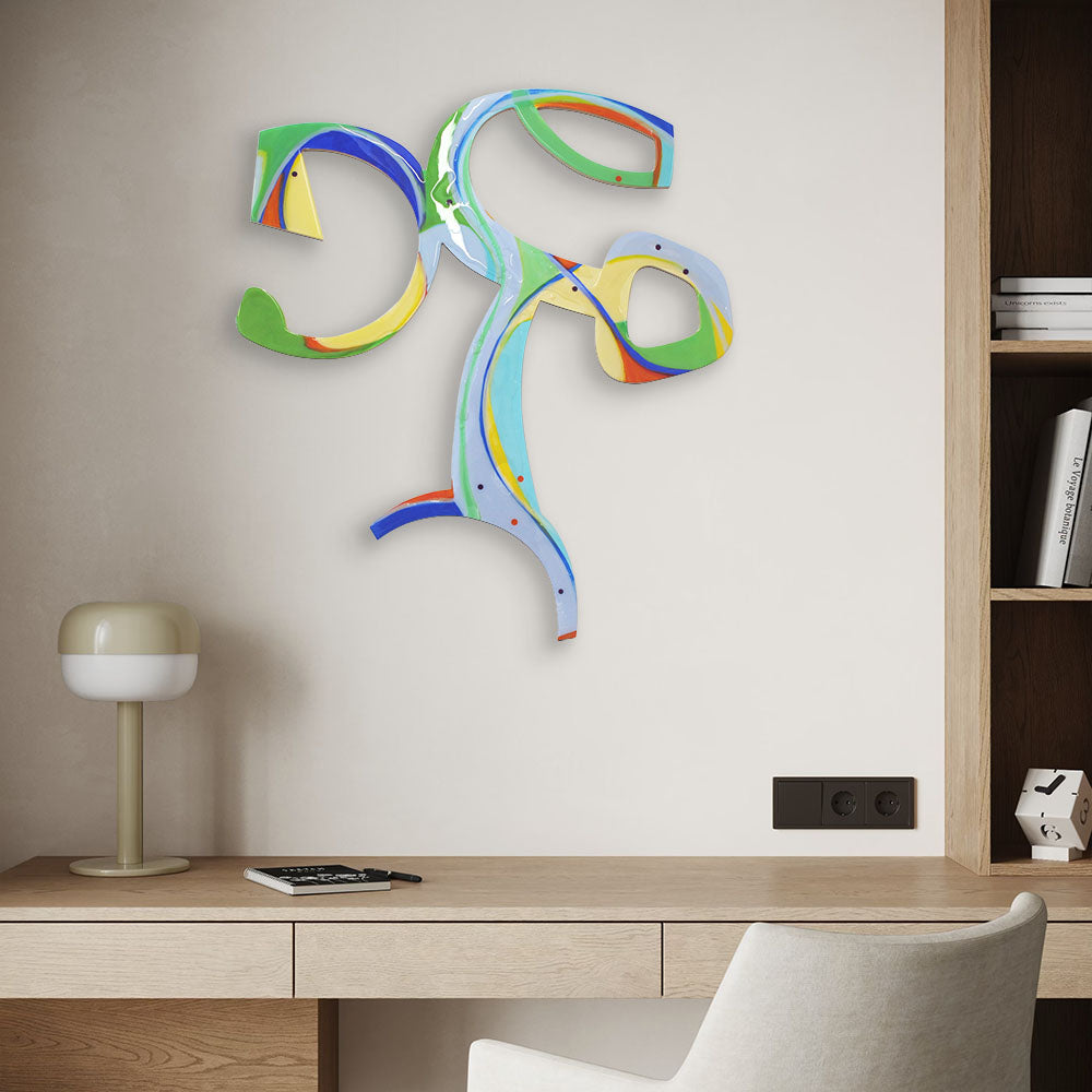 Cartwheeling Crustacean wall sculpture by Kirsty Black installed above a black desk and chair in a contemporary home office, its vivid green, blue and yellow forms standing out against the grey wall.