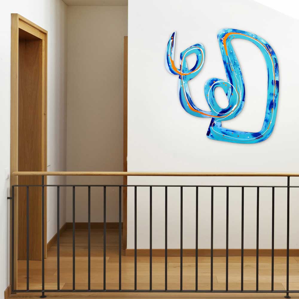 Flik Flak wall sculpture by Kirsty Black installed on a white wall above a staircase landing, its looping turquoise and cobalt forms making a bold statement in a contemporary interior.