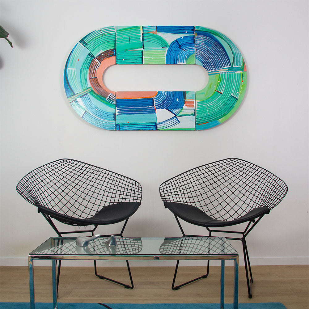 Otter Wingding, abstract wall sculpture hanging horizontally on a white wall