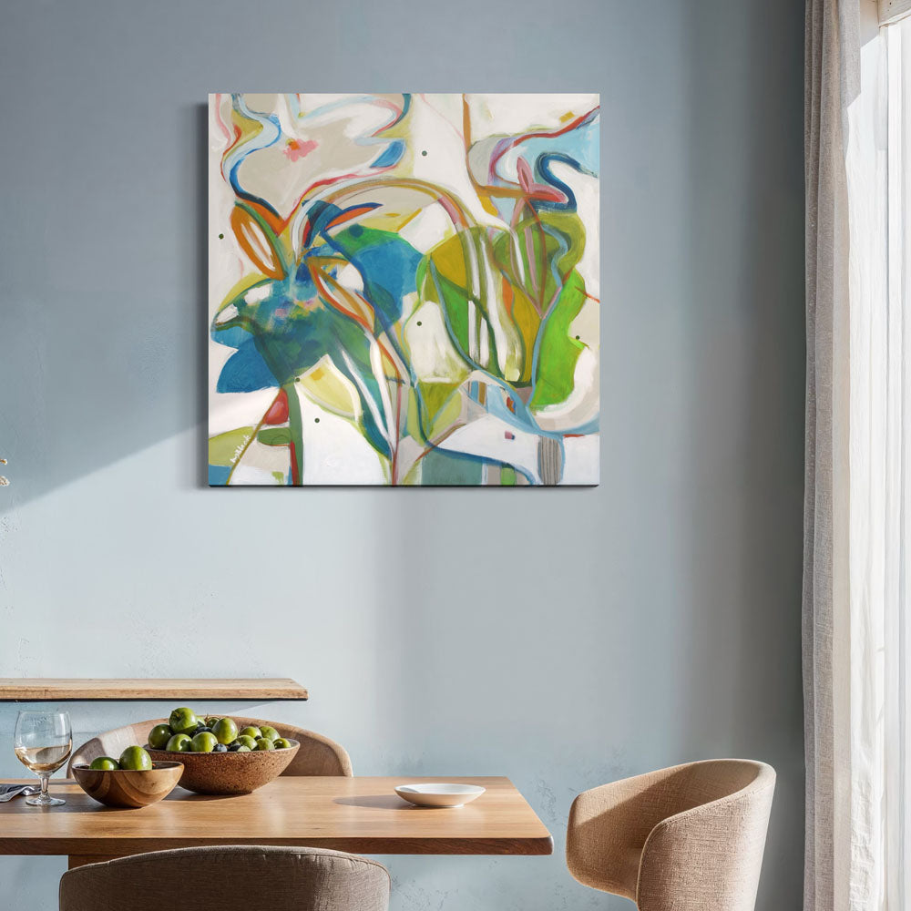 Critter Masquerade abstract painting by Kirsty Black on soft blue-grey wall above light wood dining table with beige curved chairs and green apples in wooden bowls