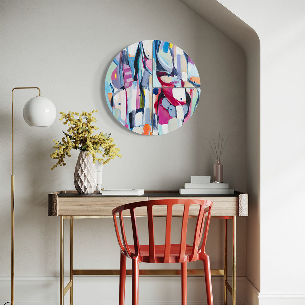 Damselfly Shimmy circular wall sculpture by Kirsty Black mounted on grey wall above timber desk in elegant home study nook with red chair, gold floor lamp and white geometric vase with yellow mimosa