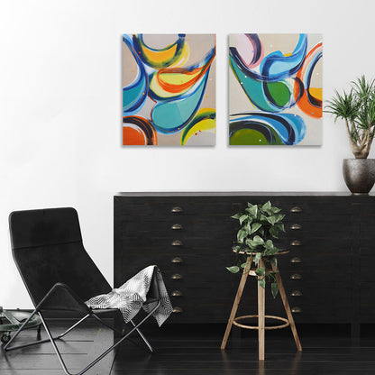 Gossip Guys and Gas Bag Gals abstract paintings by Kirsty Black hung as a pair on white wall above black flat file cabinet with leather chair and trailing ivy plant