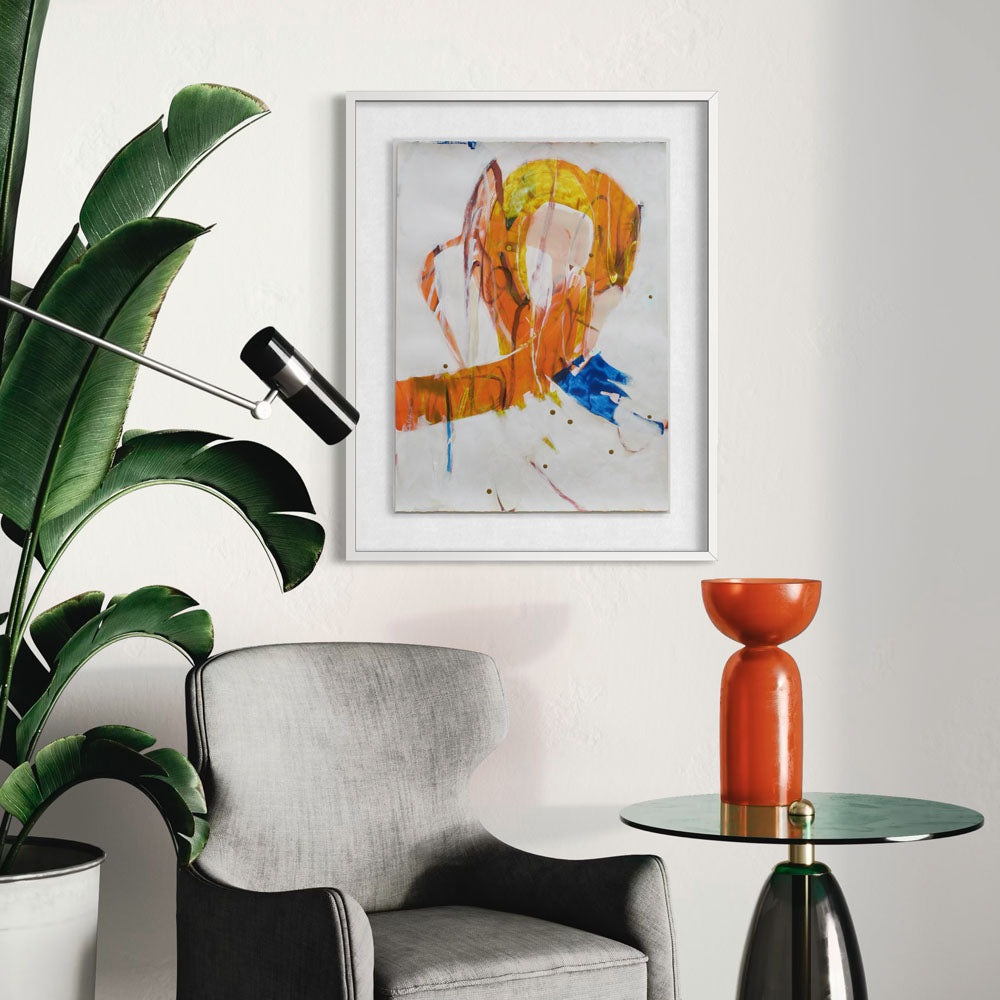 Cock A Hoop abstract painting by Kirsty Black shown in white frame on cream wall above grey armchair beside modern orange vase and green side table