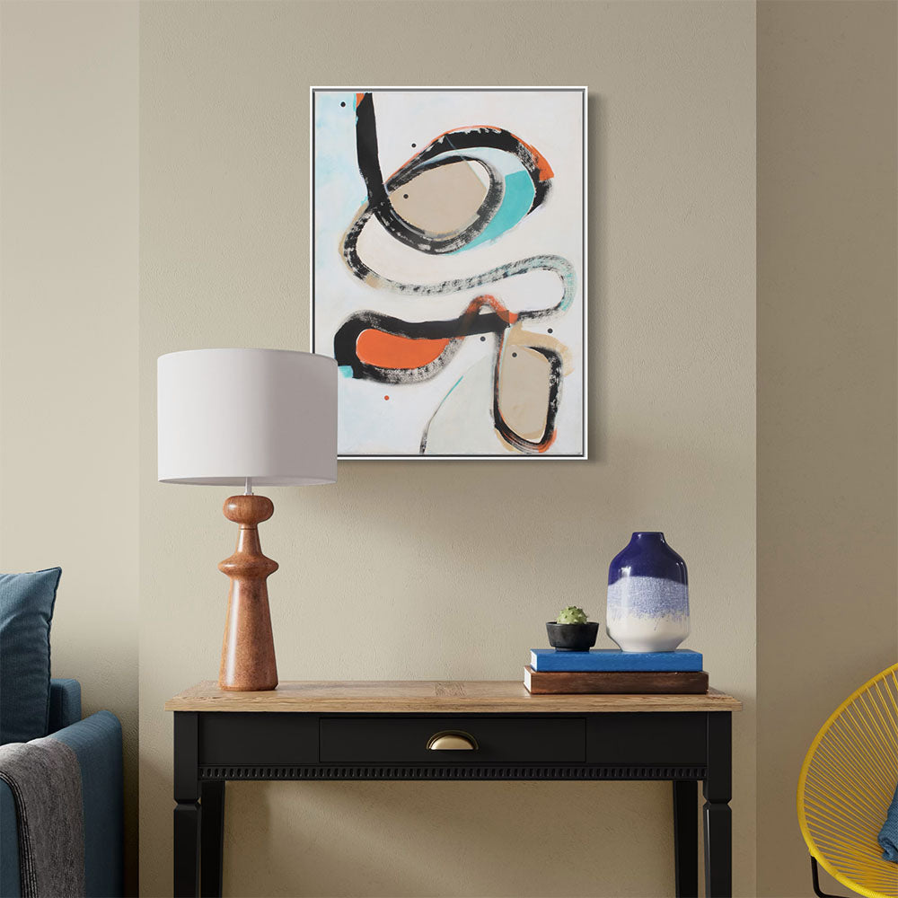 Lounge Lizard Groove abstract painting by Kirsty Black shown in white frame on olive green wall above black wooden console with wooden lamp and blue vase