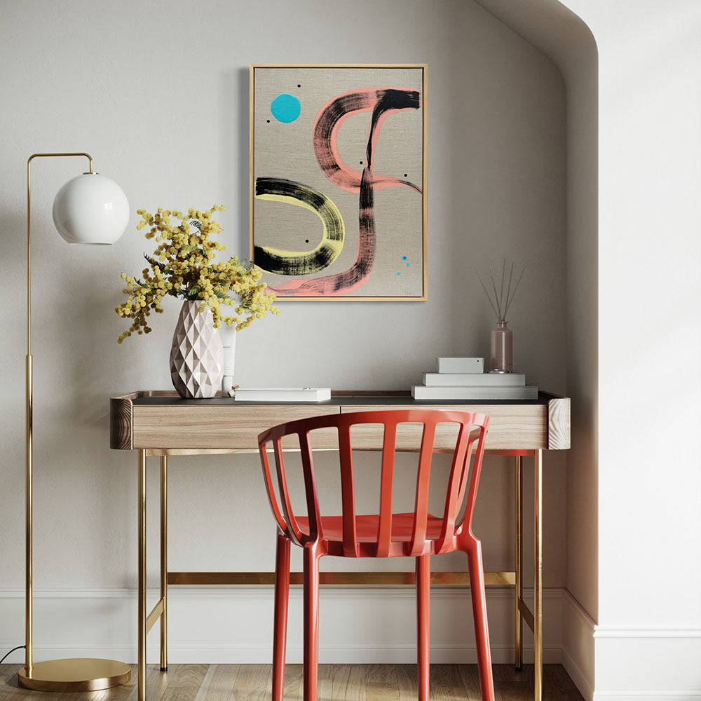 Pussy Cat Prowl framed abstract painting by Kirsty Black above timber desk in elegant home study with red chair, gold floor lamp, white geometric vase with yellow mimosa