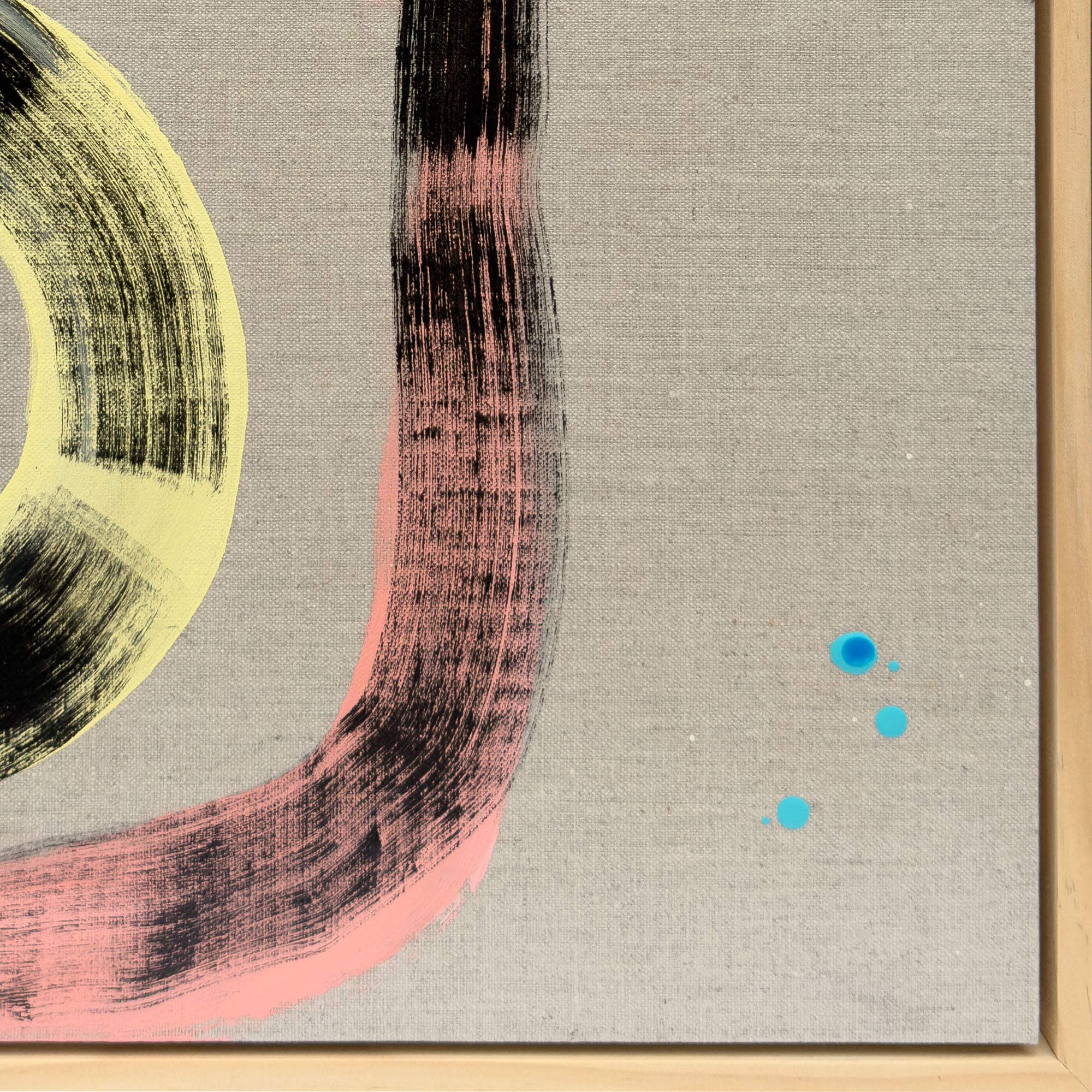 Close-up detail of Pussy Cat Prowl showing the lower pink and black sweeping arc with lime yellow curve and three vivid turquoise dots on natural linen ground in natural wood tray frame