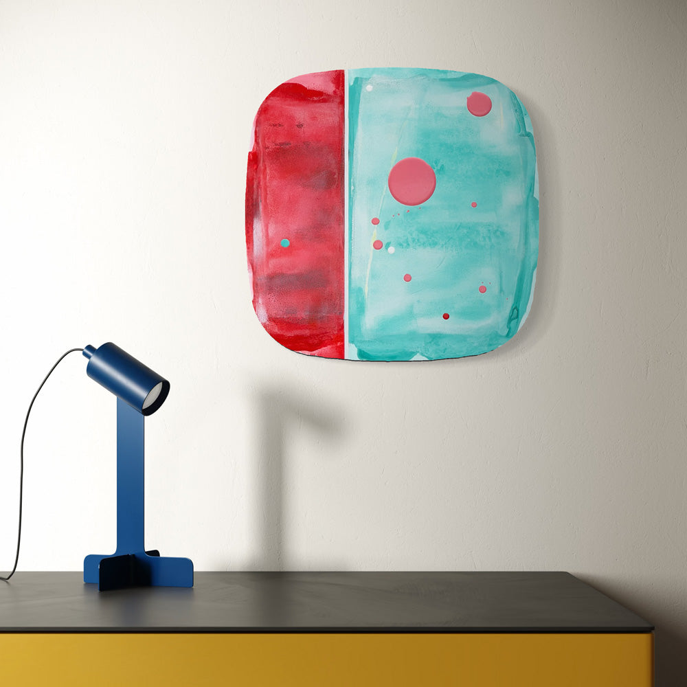 Tamarillo Sorbet, original abstract painting by Kirsty Black shown in situ above a yellow cabinet with a blue desk lamp, illustrating scale and how the bevelled plywood sits proud of the wall.
