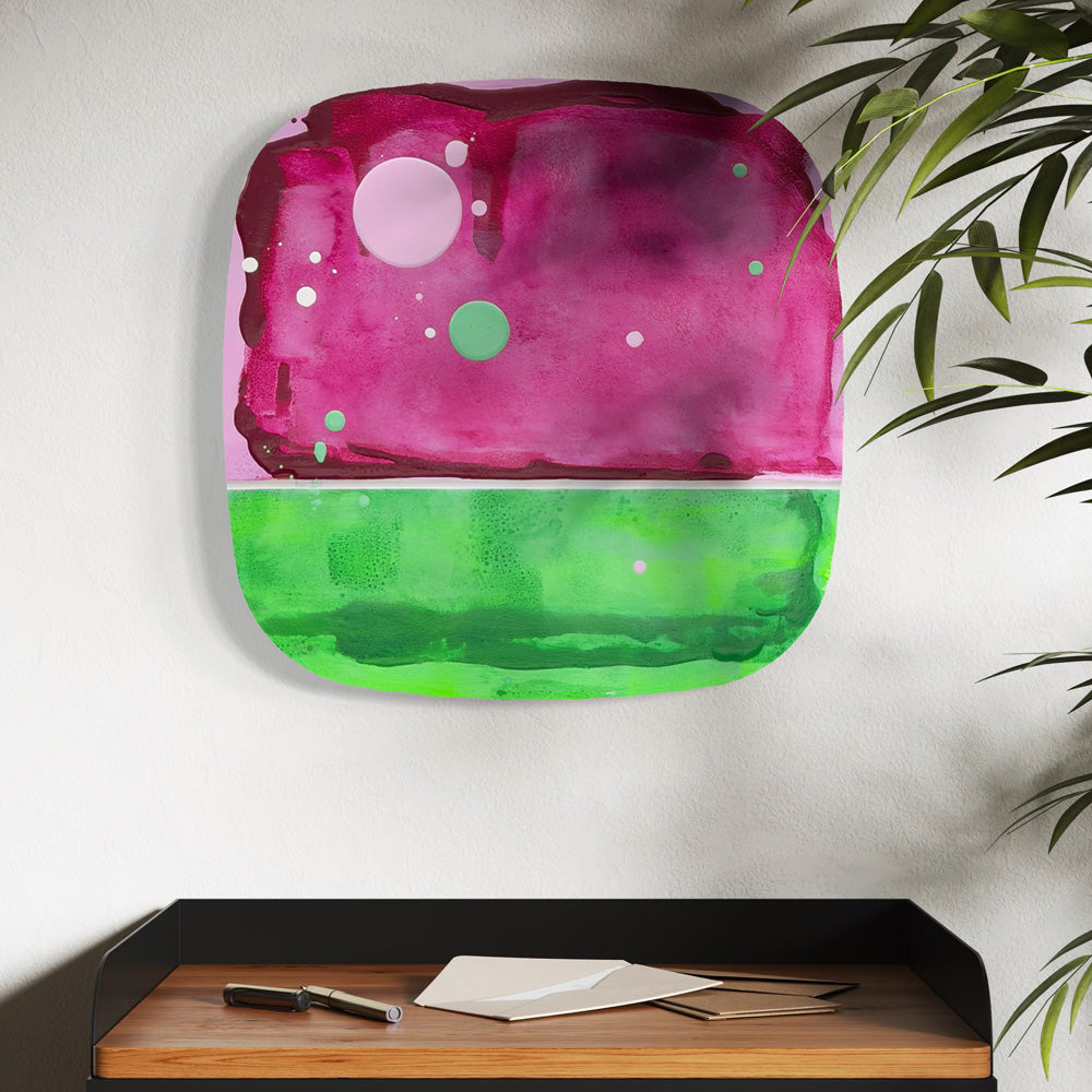Watermelon Sorbet, original abstract painting by Kirsty Black shown in situ above a desk with a plant, illustrating scale and how the bevelled plywood sits proud of the wall.